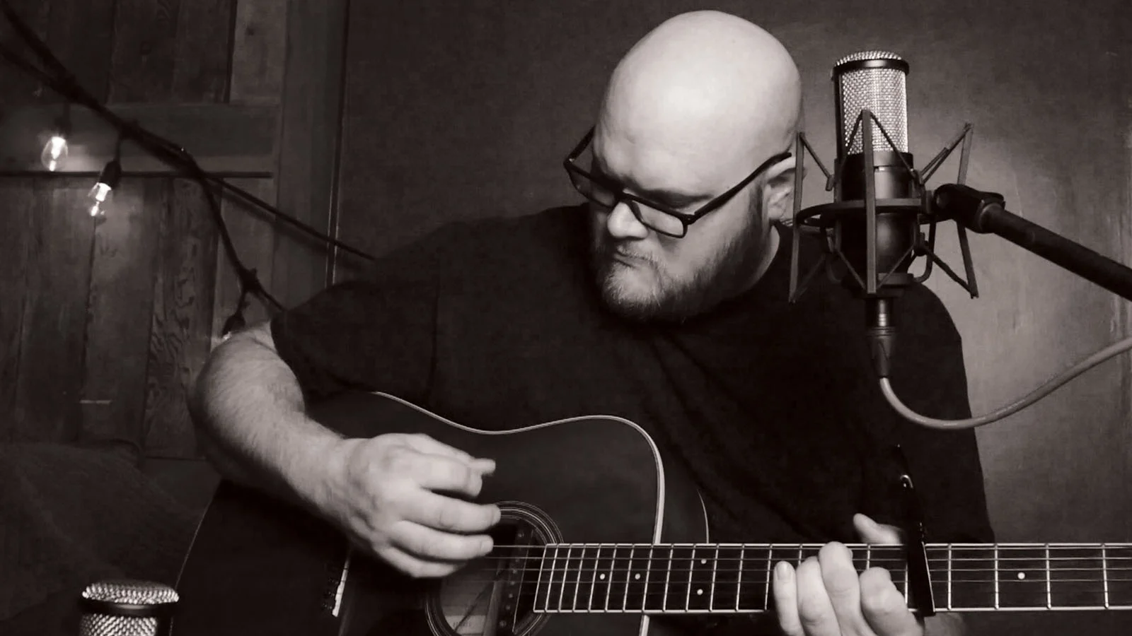 John Morton playing guitar in his studio